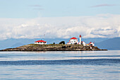 A manned lighthouse station on Entrance Island, near Nanaimo in the Georgia Straight, guides ferry traffic towards the harbour; Nanaimo, British Columbia, Canada