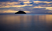 Beautiful sunrise reflected in the tranquil waters of the Pacific Ocean, Abel Tasman National Park; Nelson, New Zealand
