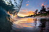 View inside breaking wave at dawn at Sunset Beach, north shore of Oahu, Hawaii Islands, USA