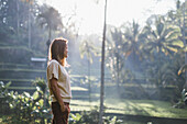 Woman standing in scenery with palm trees, Tegallalang, Bali, Indonesia