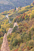 View of Cembra Valley in autumn and Segonzano Pyramids, Trentino District, Italy