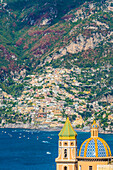 Praiano, Amalfi coast, Salerno, Campania, Italy. The church of Praiano with Positano village in the background