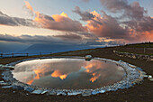 An artificial little lake at Mezzomiglio Alm, Cansiglio, Farra d'Alpago, Belluno, Italy