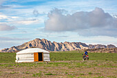 Nomadic people on a motorbike and Mongolian ger, Middle Gobi province, Mongolia