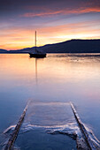 Emerged boat rails at Sasso Moro dock during an autumnal sunset, Sasso Moro, Leggiuno, Lake Maggiore, Varese Province, Lombardy, Italy