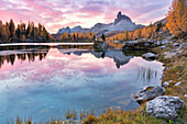 Colorful sunrise at Federa lake in autumn with yellow larches around it, Cortina d Ampezzo, Belluno, Dolomites, Veneto, Italy