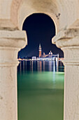 glimpse of the island of San Giorgio Maggiore framed between the columns of a bridge, Venice, Veneto, Italy