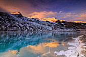 Stunning sunrise on the frozen Lago Bianco(White Lake), Bernina Pass, Engadine, Graubünden, Switzerland