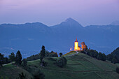 The iconic Jamik church, with Mount Triglav on the background. Jamnik, Kranj, Upper Carniola, Slovenia.