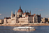 Excursion boat on the Danube River, Parliament Building at sunset, UNESCO World Heritage Site, Budapest, Hungary, Europe