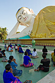 Reclining Buddha and Buddhist devotees, Bagan (Pagan), Myanmar (Burma), Asia