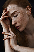 Close up of pensive Caucasian woman with freckles