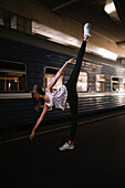 Caucasian woman dancing near train