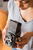 African American woman using old-fashioned camera