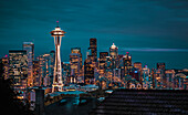 Seattle city skyline at night with urban office buildings and Space Needle viewed from garden near Kerry Park, Seattle, Washington State, United States of America, North America