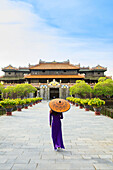 Woman in a traditional Ao Dai dress with a paper parasol in the Forbidden Purple City of Hue, UNESCO World Heritage Site, Thua Thien Hue, Vietnam, Indochina, Southeast Asia, Asia