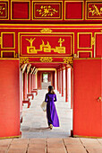 A woman in a traditional Ao Dai dress in the Forbidden Purple City of Hue, UNESCO World Heritage Site, Thua Thien Hue, Vietnam, Indochina, Southeast Asia, Asia