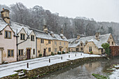 Snow covered houses by By Brook in Castle Combe, Wiltshire, England, United Kingdom, Europe