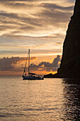 Boat moored at the base of Petit Piton near Sugar Beach at dusk, St. Lucia, Windward Islands, West Indies Caribbean, Central America