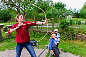 Archery tourist in the Stone Age village Kussow, Baltic Sea Coast, Mecklenburg-Vorpommern, Germany