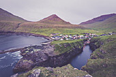 The village of Gjogv in between mountains and ocean, Eysturoy Island, Faroe Islands, Denmark, Europe