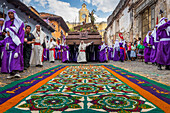 Good Friday Procession approaching a sawdust carpet during Holy Week 2017 in Antigua, Guatemala, Central America