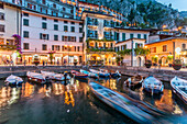 View of illuminated promenade at the port of Limone at dusk, Lake Garda, Lombardy, Italian Lakes, Italy, Europe