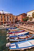 View of boats in Malcesine Harbour by the Lake, Malcesine, Lake Garda, Veneto, Italian Lakes, Italy, Europe