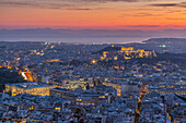 View of Athens and The Acropolis from Likavitos Hill and Aegean Sea visible on horizon at sunset, Athens, Greece, Europe