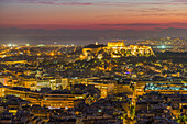 View of Athens and The Acropolis from Likavitos Hill with the Aegean Sea visible on horizon at dusk, Athens, Greece, Europe