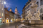 View of Cathedral of St. Nicholas and Robba fountain at dusk, Ljubljana, Slovenia, Europe