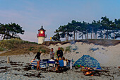 Family with motorboat picnic on the beach at the lighthouse Hellen, Hiddensee, Ruegen, Ostseekueste, Mecklenburg-Vorpommern Germany