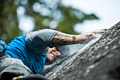 Climber bouldering near Elbow Lake in Fraser Valley, Harrison Mills, British Columbia, Canada