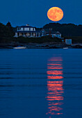 The full Buck Moon, also known as the Thunder Moon, rises over Basket Island off of Hills Beach in Biddeford, Maine, USA on Sunday, July 9, 2017.