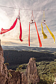 Female aerial silk gymnasts performing over forested landscape 30 meters above ground, Lower Austria, Austria