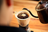 Percolating coffee by pouring water, Oakland, USA