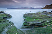 The Isle of Rum from Singing Sands on the Isle of Eigg, Small Isles, Inner Hebrides, Scottish Highlands, Scotland, United Kingdom, Europe