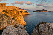 View to Lovrijenac Fortress (St. Lawrence Fortress), the city walls and Lokrum Island at sunset, Croatia, Europe