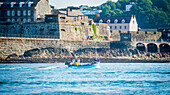 Traditional Guernsey crab and lobster boat coming into St. Peter Port Harbour, passing Castle Cornet, Guernsey, Channel Islands, United Kingdom, Europe