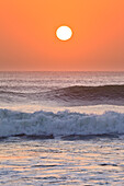 Sun setting over ocean, Cape Cross, Namibia