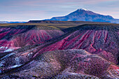 Clay rock formations and volcano, Valley of the Moon, Abra Granada, Andes, northwestern Argentina