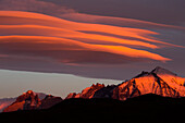 Clouds at sunrise over mountain range, Torres del Paine National Park, Patagonia, Chile