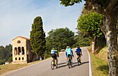 Road bikes racing, Church of St Mary at Mount Naranco, Santa Maria del Naranco, Roman Catholic Asturian pre-Romanesque architecture, Oviedo, Asturias, Spain