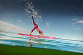 Yoga Teacher on SUP Board,  Lake Starnberg, Bavaria, Germany