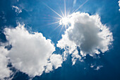 Cumulus clouds with sun and blue sky, fluffy clouds