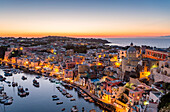 Procida, sunset over La Corricella harbour. Naples, Campania, Italy