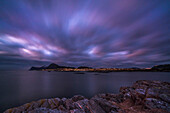 Cloudy sunset at Langevag with the view toward Alesund and the islands Heisa and Godoya on background. Langevag, Vestlandet, More og Romsdal county, Norway, Europe.