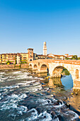 Ponte Pietra (Stone Bridge) and Verona old town at sunrise. Verona, Veneto, Italy