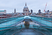 St. Paul’s Cathedral from Millennium Bridge during a cloudy dawn, London, Great Britain, UK