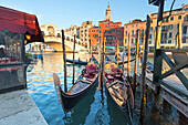 Two traditional venetian gondolas in front of Rialto Bridge, Canal Grande, Venice, Veneto, Italy